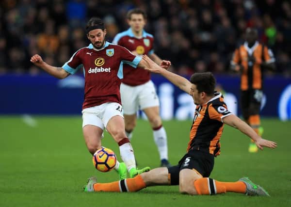 Hull City's Harry Maguire challenges Burnley's George Boyd at the KCOM Stadium last Saturday (Picture: Mike Egerton/PA Wire).