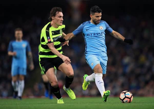 Huddersfield Town's Dean Whitehead challenges Manchester City's Sergio Aguero in Wednesday's FA Cup replay (Picture: Mike Egerton/PA Wire).