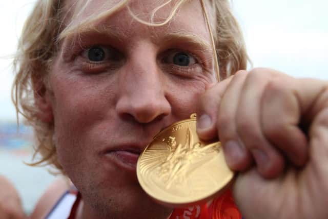 Great Britain's Andrew Triggs Hodge kisses his medal after winning gold during the mens four final at the Shunyi Olympic Rowing-Canoeing Park during the 2008 Beijing Olympic Games, China.
