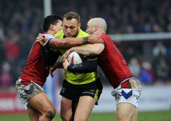 Wakefield's Ken Sio and Liam Finn tackle by Hull's Josh Griffin.