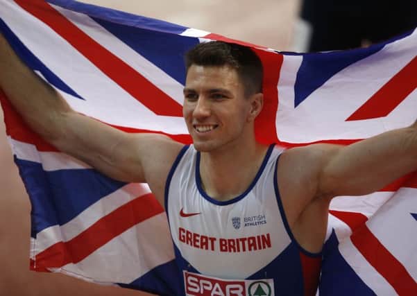 Britain's Andy Pozzi celebrates winning the men's 60-meter hurdles final.