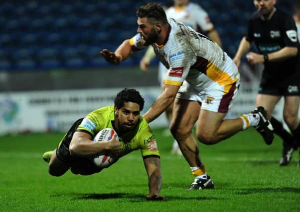 Hull's Albert Kelly dives past Huddersfield's Shannon Wakeman to score his second try.