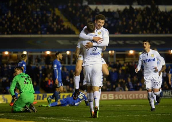 An admiring Kalvin Phillips leaps into the arms of goalscorer Chris Wood to celebrate the strikers 25th goal of the season for Leeds United (Picture: Bruce Rollinson).