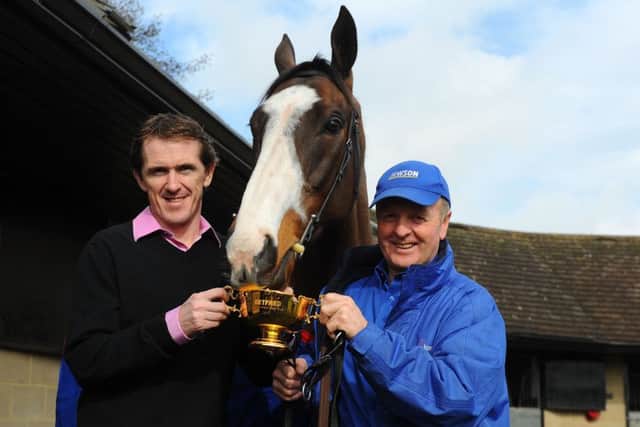 Cheltenham Gold Cup winning jockey Tony McCoy (left) and trainer Jonjo O'Neill (right) with Synchronised during a stable visit to Jackdaws Castle, Temple Guiting.