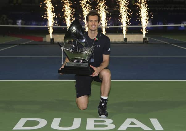 Andy Murray of Great Britain holds the trophy after he beats Fernando Verdasco of Spain during the final match of the Dubai Tennis Championships. (AP Photo/Kamran Jebreili)