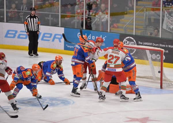 Beaten: The blue-shirted Sheffield Steelers are unable to prevent the puck from squeezing past goalie Ervins Mustukovs during their 3-2 Cup final defeat to Cardiff. (Picture: Dean Woolley)