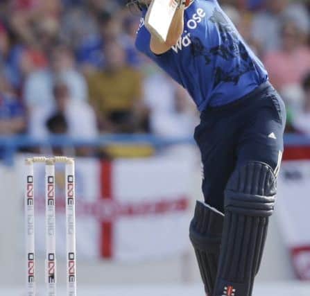 BANG: Chris Woakes drives England towards victory off the bowling of West Indies captain Jason Holder in Antigua. Picture: AP/Ricardo Mazalan