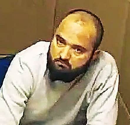 Police picture of Tanveer Ahmed being interviewed