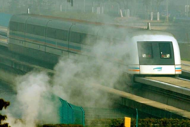 The magnetic levitation train runs though a steam cloud at Pudong International Airport station in Shanghai, China.