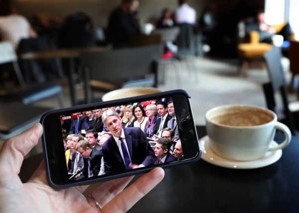 A smartphone shows the Chancellor Philip Hammond making his Budget statement