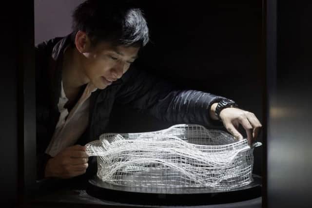 Japanese artist Akinori Goto installing his 3D zoetrope