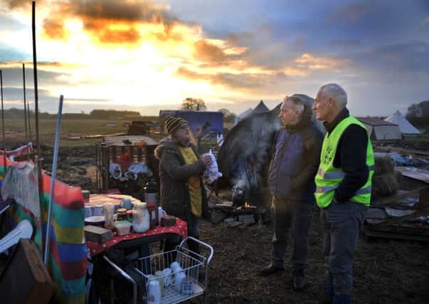 Two of the anti fracking  walkers chat with a resident of the camp at Kirby Misperton as the sun rises , before they set off to Blackpool on the anti fracking march. Picture Gary Longbottom.