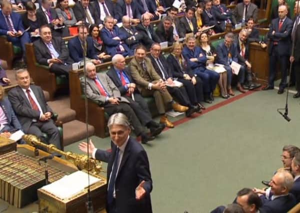 Chancellor of the Exchequer Philip Hammond gestures while making his Budget statement to MPs in the House of Commons.
