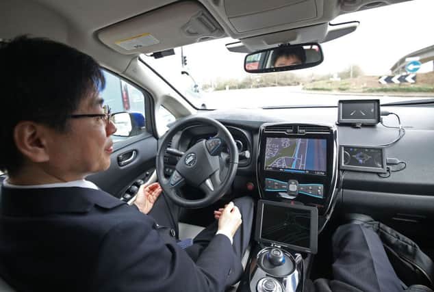 Tetsuya Lijima from Nissan giving a demonstration around the roads of east London of a prototype Nissan Leaf driverless car.