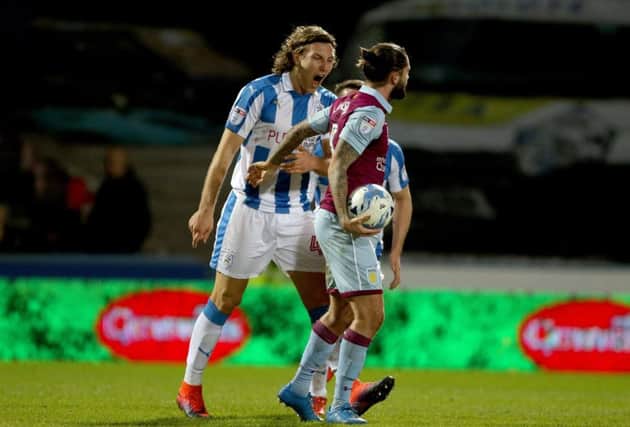 LISTEN HERE: Huddersfield Town's Michael Hefele gets something off his chest to Aston Villa's Henri Lansbury on Tuesday night at the John Smith's Stadium. Picture: Richard Sellers/PA.