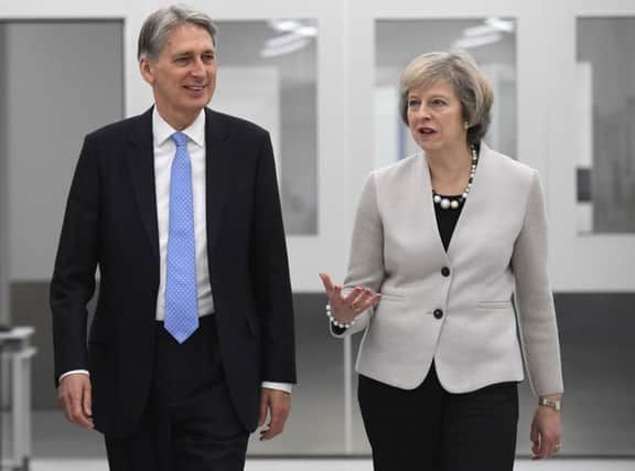 Theresa May and Philip Hammond are backtracking over tax.
