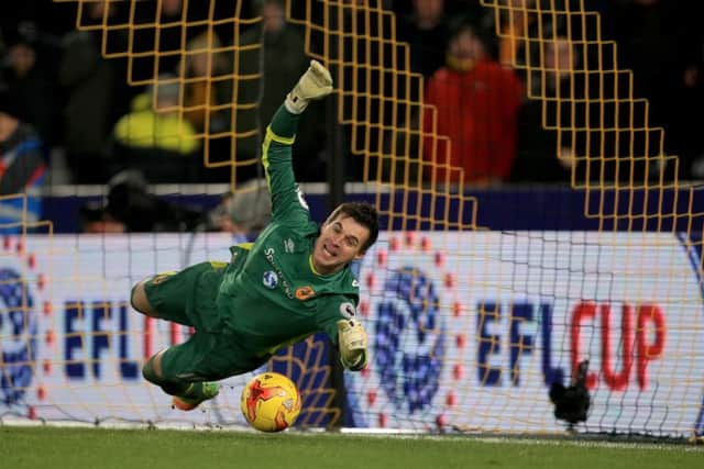 Hull City goalkeeper Eldin Jakupovic saves a penalty from Newcastle United's Jonjo Shelvey during the EFL Cup, Quarter Final last year.