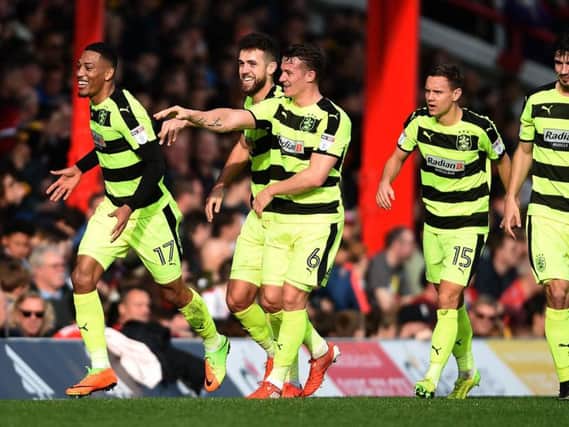 Rajiv Van la Parra celebrates with his Huddersfield teammates after scoring in the first half (Photo: PA)