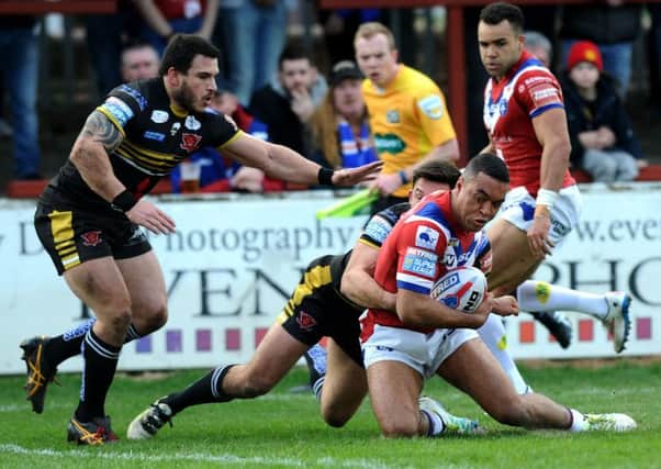 Wakefield's Reece Lyne goes over to score the first try.