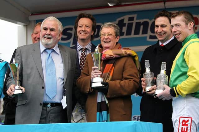 Owners Alan Potts (left) and Ann Potts (centre) collect their trophies after Sizing Europe wins the Queen Mother Champion Chase at Cheltenham in 2011. Picture: David Davies/PA.