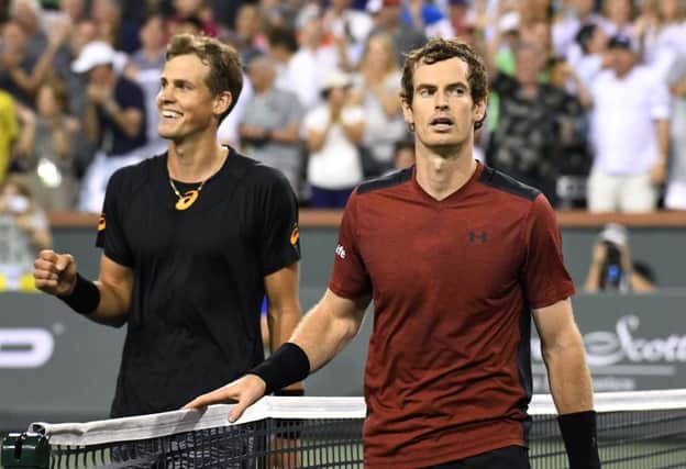 Joy and the pain: Vasek Pospisil, left, cant hide his delight after beating Britains Andy Murray in the second round of the BNP Paribas Open tournament  in Indian Wells. Picture:  AP.