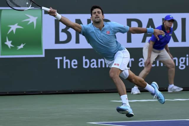 Novak Djokovic stretches to hit a forehand return against Kyle Edmund on Sunday night in Indian Wells. Picture: AP/Mark J. Terrill