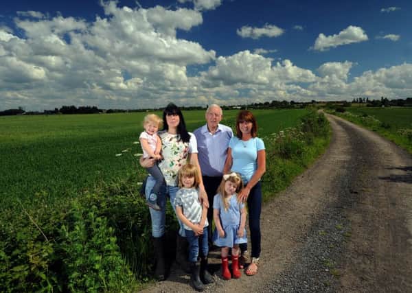 Residents on Dunningley Lane Tingley, fear for there countryside as hundreds of houses are proposed to be built on the land..Coun Jack Dunn is pictured with residents Sarah Chilvers with her children Kingsley aged 5 and Ramone aged 2, and Lesley Griffin with her Granddaughter Eva Riley aged 4..1001448a..10th June 2014 ..Picture by Simon Hulme