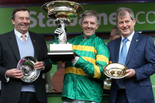 Trainer Nicky Henderson, jockey Noel Fehily with the Stan James Champion Hurdle Challenge Trophy, and Buveur Air's owner John McManus.