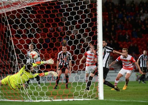 James Coppinger scores Doncaster Rovers equaliser past Notts Countys goalkeeper Adam Collin (Picture: Bruce Rollinson).
