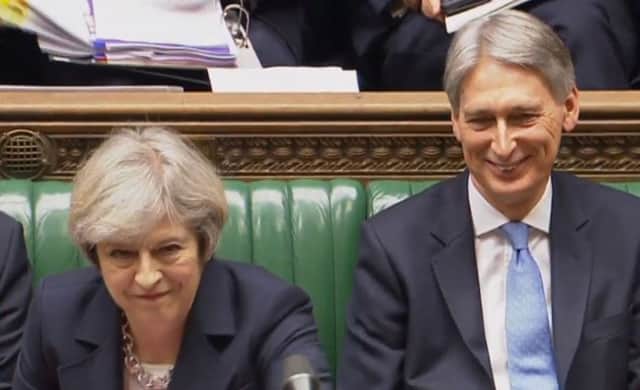 Theresa May and Philip Hammond at PMQs as the Budget U-turn was announced.