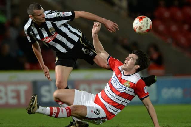 John Marquis falls as Haydn Hollis clears the ball.
 (Picture: Bruce Rollinson)