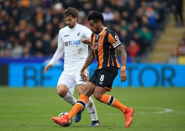 Hull City's Tom Huddlestone (right) battles with Swansea City's Fernando Llorente (left) last weekend. Picture: Nigel French/PA.
