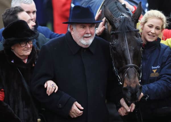 Owners Anne and Alan Potts celebrate with stable groom Ashley Hussey, right, after Sizing John's winning ride in the Cheltenham Gold Cup  (Picture: Mike Egerton/PA Wire).