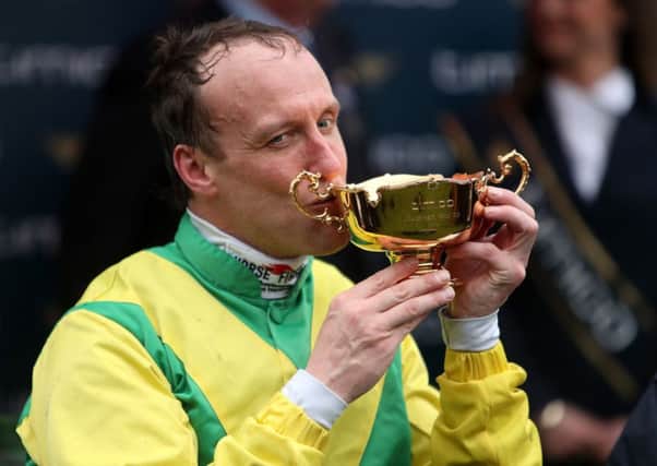 Jockey Robbie Power celebrates with the Cheltenham Gold Cup after his winning ride on Sizing John (Picture: David Davies/PA Wire).