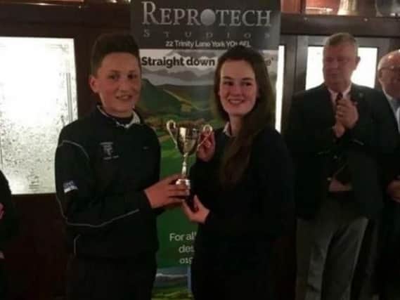 Captains Angus Gray (Harrogate Union) and Lucy Walker (York Union) with the Reprotech Trophy after last year's 3-3 draw at Bedale GC.