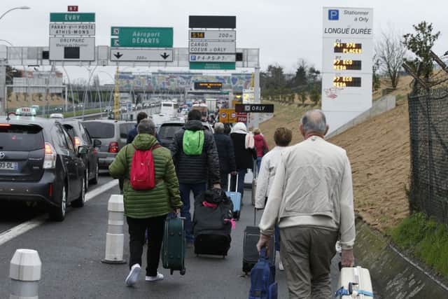 French police say a man was shot to death after trying to seize the weapon of a soldier guarding Paris' Orly Airport.