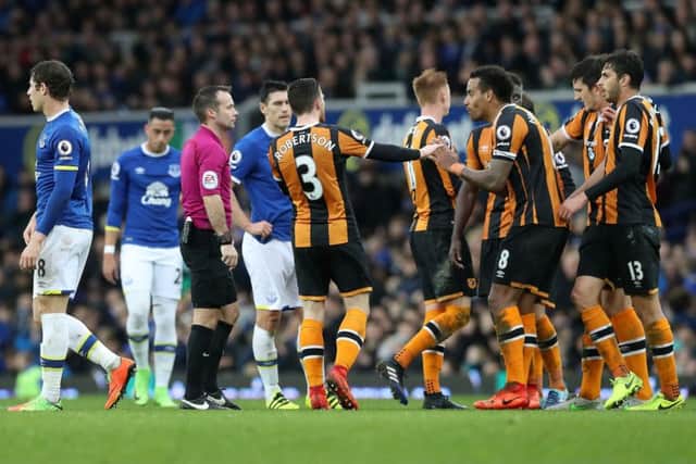 Hull City's Tom Huddlestone (second right) is surrounded after being sent off at Goodison Park. Picture: Martin Rickett/PA.