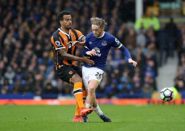 Hull City's Tom Huddlestone (left) and Everton's Tom Davies (right) battle for the ball. Picture: Martin Rickett/PA.