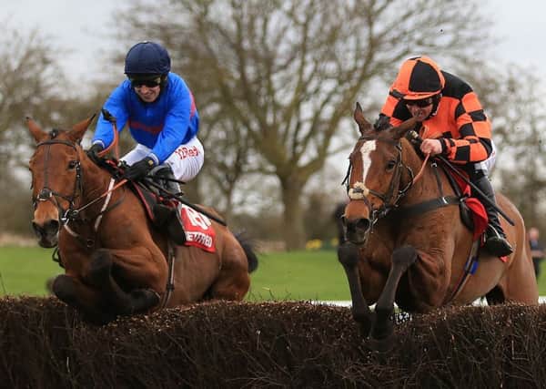 Chase The Spud and Paddy Brennan, left, going on to win the Midlands Grand National ahead of Mystree and Robert Dunne (Picture: PA).