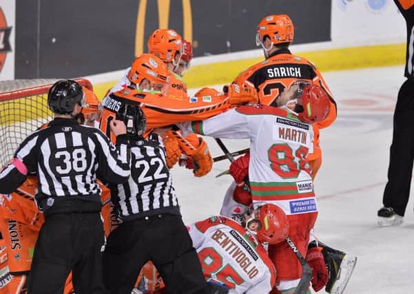 ROUGH AND TUMBLE: Sheffield Steelers' Guillaume Desbiens gets to grip with Cardiff Devils' Joey Martin during Saturday night's clash. Pictures: Dean Woolley.