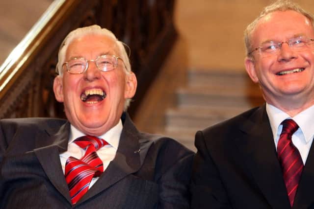 First Minister Ian Paisley and Deputy First Minister Martin McGuinness smiling after being sworn in as ministers of the Northern Ireland Assembley