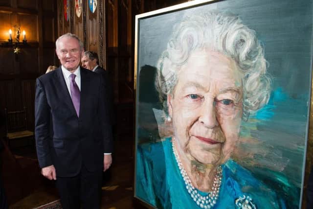 Martin McGuinness at a Co-operation Ireland reception, with a portrait of the Queen by artist Colin Davidson.