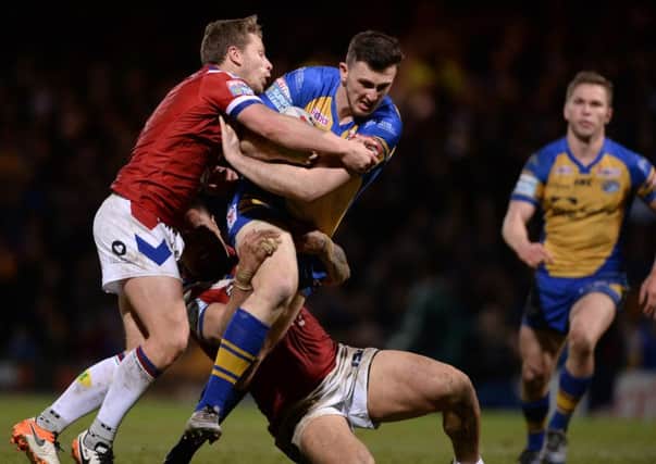 AIMING HIGH: Jordan Baldwinson is held by Wakefield's Kyle Wood and Tinirau Arona at Headingley last Friday.  Picture Bruce Rollinson