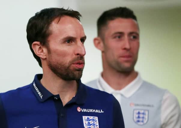 Gareth Southgate, who takes charge of his first match today since being appointed full-time England manager, with Gary Cahill, the Chelsea defender who will captain the Three Lions side against Germany in Dortmund (Picture: Mike EgeRton/PA Wire).