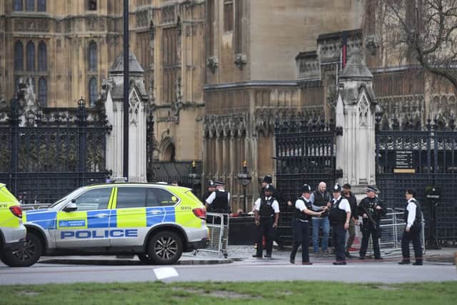 Police outside the Palace of Westminster, London, after sounds similar to gunfire have been heard