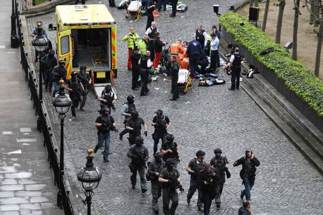 Armed police in the immediate aftermath of the terrorist attack at Westminster which exemplified the best and worst of humanity.