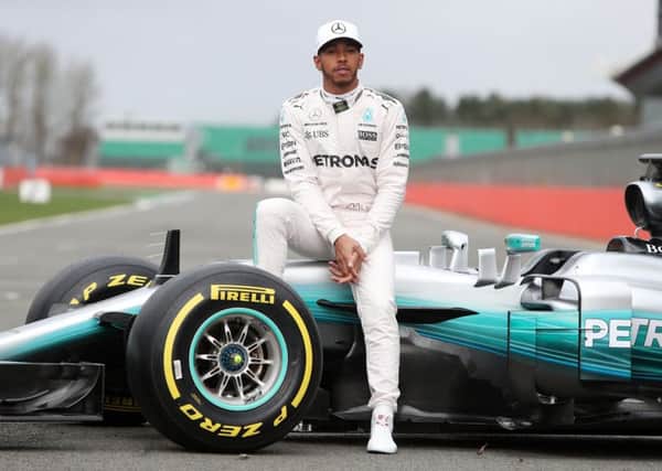 Bring it on: Lewis Hamilton with the new Mercedes W08 Formula 1 car he plans to regain the title in. (Picture: David Davies/PA)