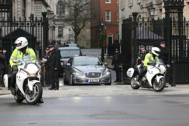 Prime Minister Theresa May leaves 10 Downing Street in London, after seven people were arrested in raids in London, Birmingham