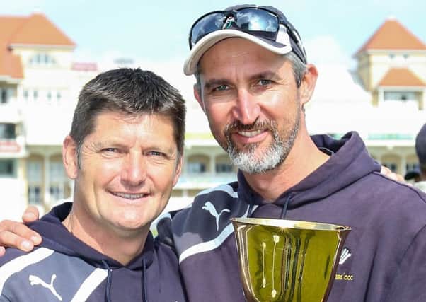 Crowning glory: Yorkshire director of cricket Martyn Moxon, left, and first-team coach Jason Gillespie celebrate with the County Championship Division One trophy at Trent Bridge, Nottingham in 2014. Pictures: SW PIX