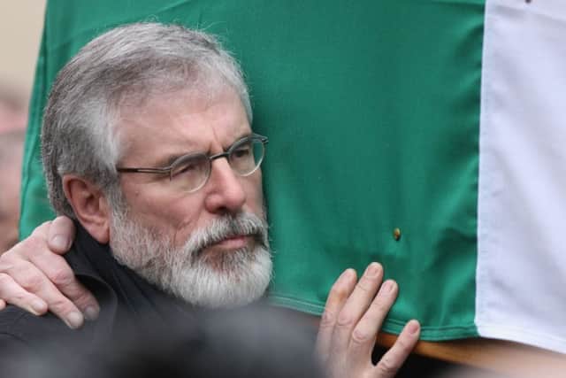 Gerry Adams carries the coffin during the funeral procession of Northern Ireland's former deputy first minister and ex-IRA commander Martin McGuinness